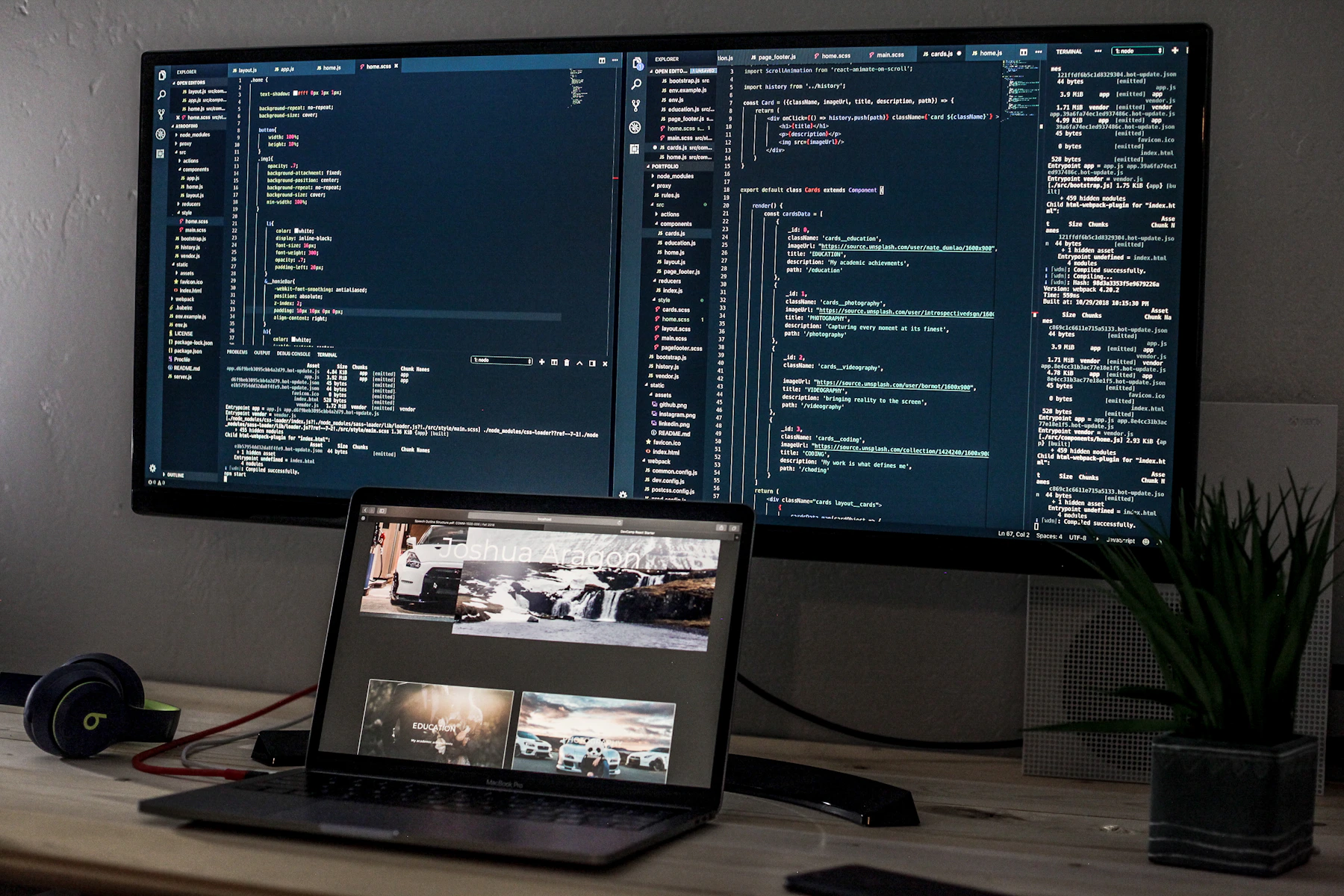 Software development workstation with code displayed on multiple screens